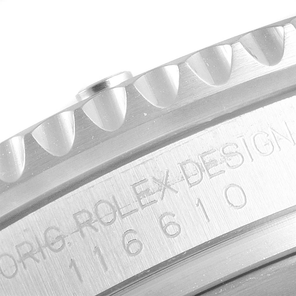 The image shows a close-up of the Rolex Submariner 116610 Men
s Stainless Steel Black Dial 116610 Men
s Stainless Steel Black Dial
s engraved bezel and case, displaying part of the model number and "ORIG. ROLEX DESIGN".