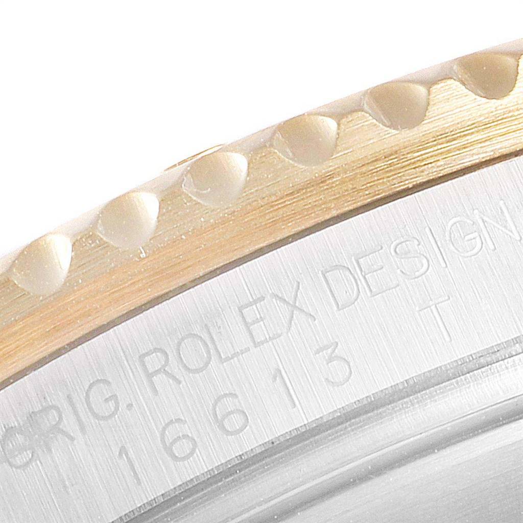The image shows a close-up of the bezel and case back of the Rolex Submariner 16613 Men
s Steel and Gold (two tone) Blue Dial 16613 Men
s Steel and Gold (two tone) Blue Dial, featuring the engraved model number and design details.
