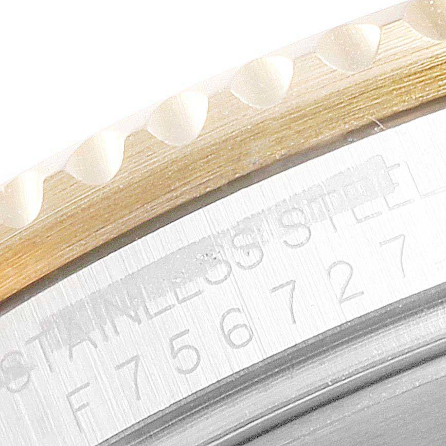 The image shows a close-up angle of the bezel and part of the engraved case of the Rolex Submariner 16613 Men
s Steel and Gold (two tone) Blue Dial 16613 Men
s Steel and Gold (two tone) Blue Dial watch.