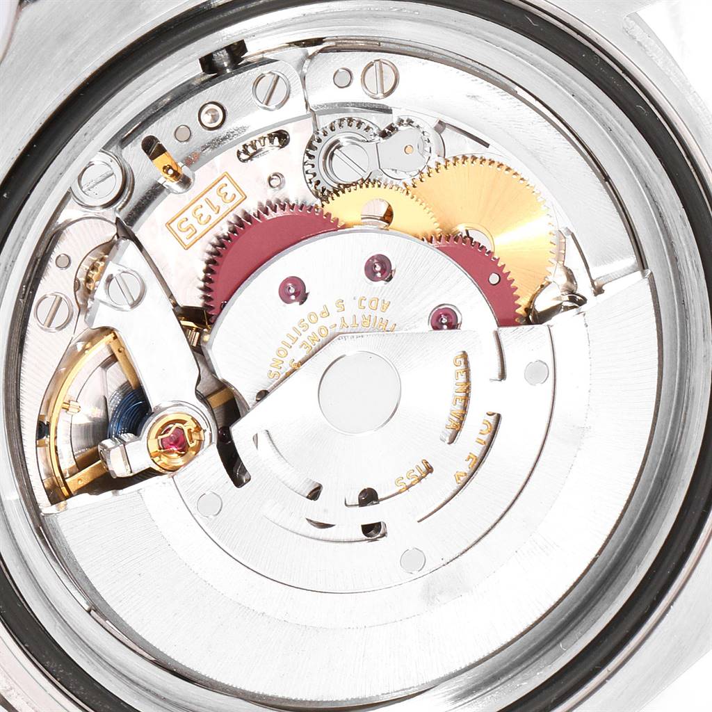 The image shows the internal mechanical movement of a Rolex Submariner 116610LV Men
s Stainless Steel Green Dial 116610LV Men
s Stainless Steel Green Dial watch from a back angle.