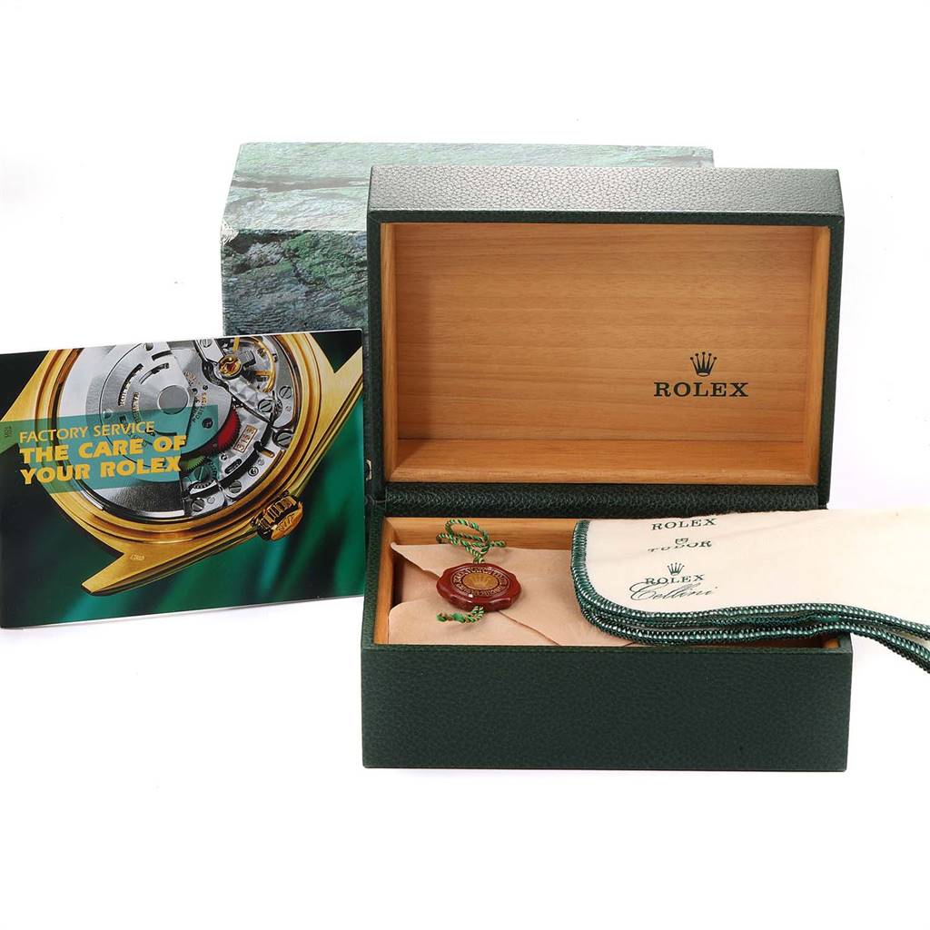 The image shows a Rolex Submariner 16613 Men
s Steel and Gold (two tone) Black Dial 16613 Men
s Steel and Gold (two tone) Black Dial watch box set with an open box, booklet, tag, and cleaning cloth.