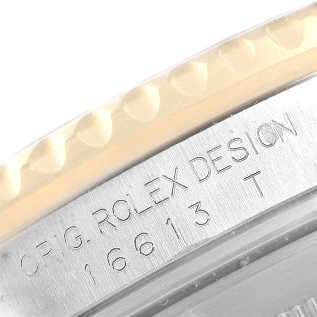 This image shows a close-up of the engraving on the side of the casing of a Rolex Submariner 16613 Men
s Steel and Gold (two tone) Black Dial 16613 Men
s Steel and Gold (two tone) Black Dial watch.