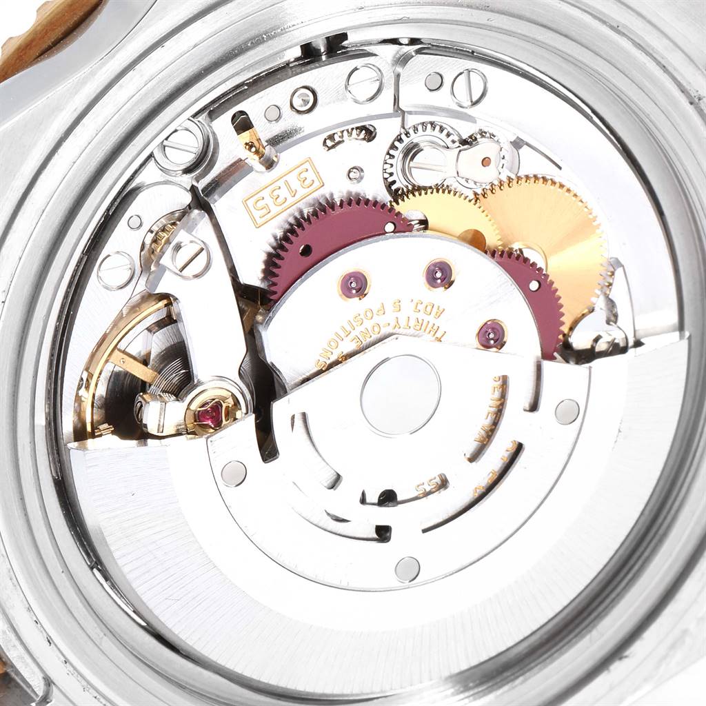 This image shows the intricate internal mechanism of a Rolex Submariner 16613 Men
s Steel and Gold (two tone) Black Dial 16613 Men
s Steel and Gold (two tone) Black Dial watch from a close-up angle.