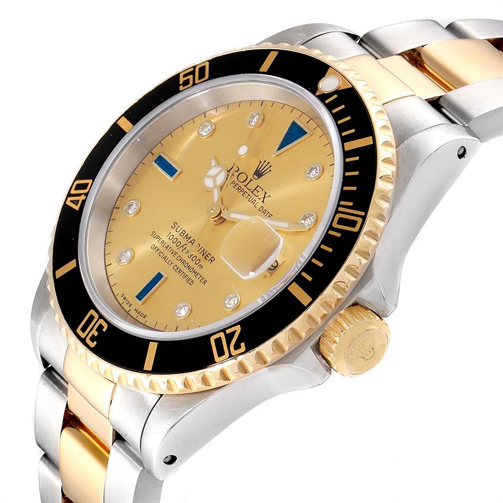 The image shows a Rolex Submariner 16613 Men
s Steel and Gold (two tone) Champagne Dial 16613 Men
s Steel and Gold (two tone) Champagne Dial watch at a three-quarter angle, highlighting its gold and silver bracelet, bezel, and crown.