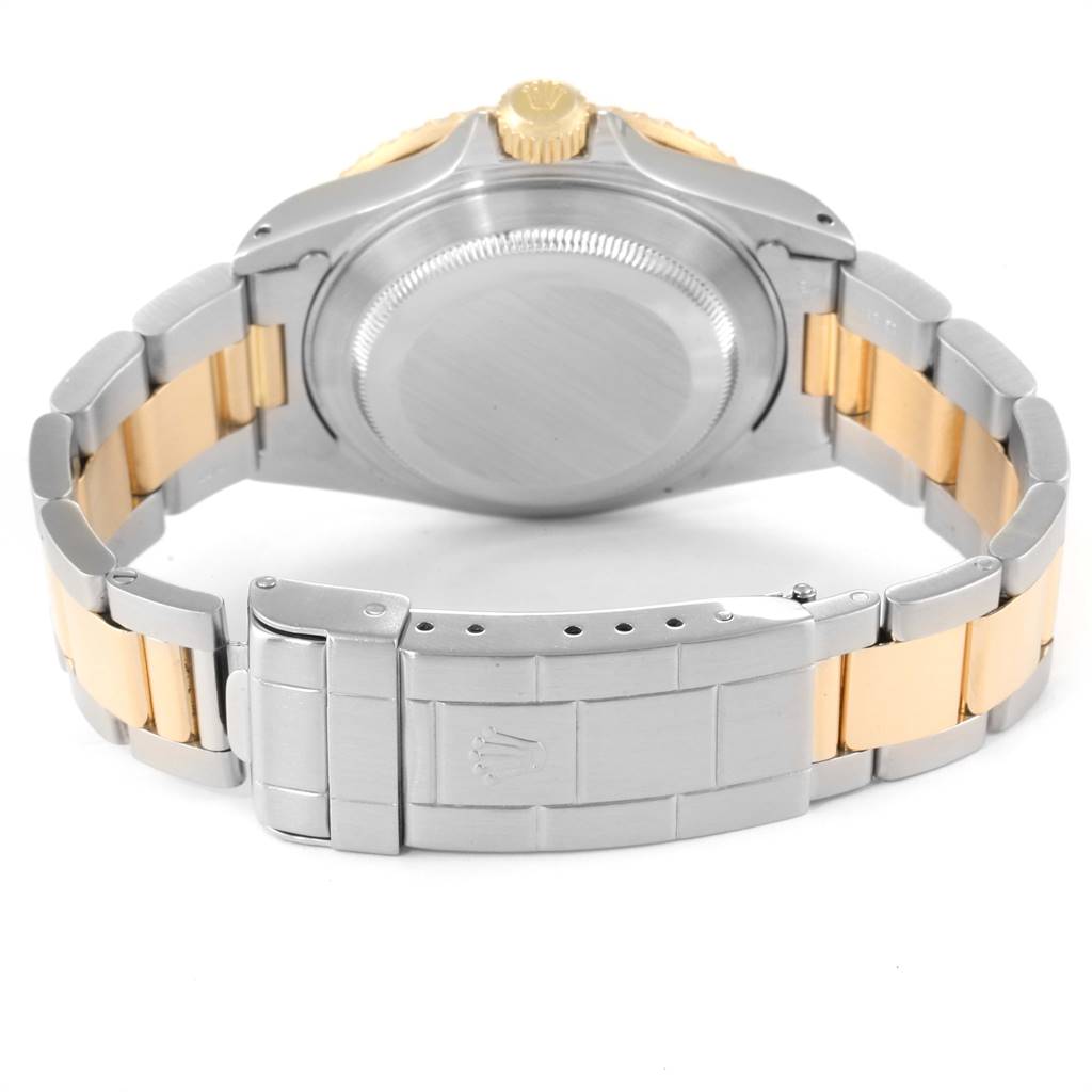 The image shows the back case and bracelet of a Rolex Submariner 16613 Men
s Steel and Gold (two tone) Champagne Dial 16613 Men
s Steel and Gold (two tone) Champagne Dial watch from a rear angle.