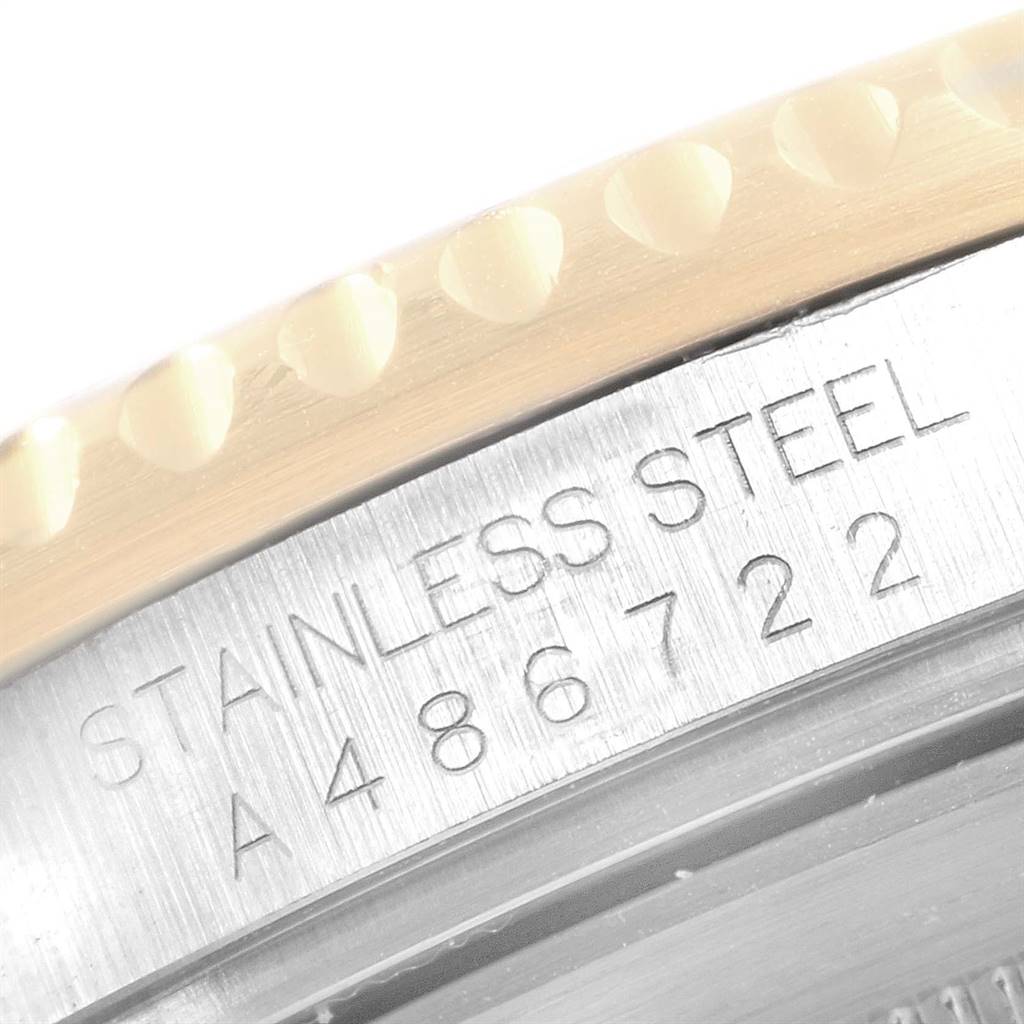 The image shows a close-up of the serial number and stainless steel engraving on the case of a Rolex Submariner 16613 Men
s Steel and Gold (two tone) Champagne Dial 16613 Men
s Steel and Gold (two tone) Champagne Dial watch.