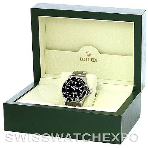 The image shows a Rolex Submariner 16610 Men's Stainless Steel Black Dial 16610 Men's Stainless Steel Black Dial watch displayed inside an open green Rolex box, emphasizing the watch face and bracelet.