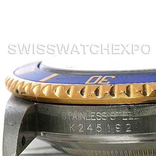 The image shows a close-up side view of a Rolex Submariner 16613 Men's Yellow Gold Blue Dial 16613 Men's Yellow Gold Blue Dial, highlighting the bezel, case, and part of the band with engraving.