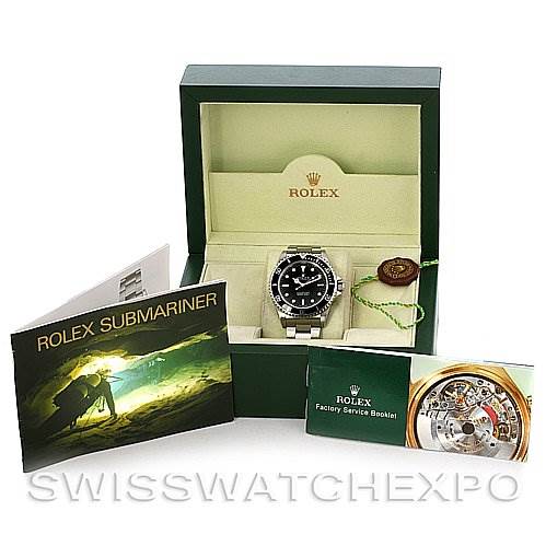 The image shows a Rolex Submariner 14060M Men
s Stainless Steel Black Dial 14060M Men
s Stainless Steel Black Dial watch front-on, inside its green box, alongside accompanying booklets and a hang tag.