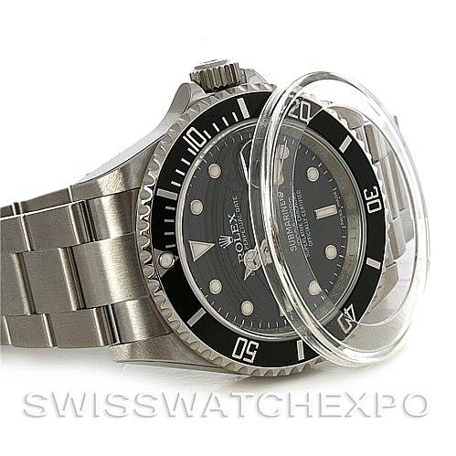 The image shows a Rolex Submariner watch at an angle with a visible bezel, dial, and part of the bracelet.