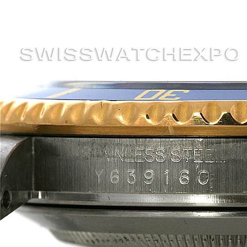 The image shows a close-up side angle shot of the Rolex Submariner 16613 Men's Yellow Gold Grey Dial 16613 Men's Yellow Gold Grey Dial model, highlighting the stainless steel case and the serial number.