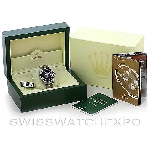 The image shows a Rolex Submariner 16610 Men
s Stainless Steel Black Dial 16610 Men
s Stainless Steel Black Dial in its box, accompanied by a manual and other official documents, all seen from a front angle.