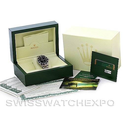 The image shows the Rolex Submariner 16610 Men
s Stainless Steel Black Dial 16610 Men
s Stainless Steel Black Dial watch and its accessories, including the box, guarantee card, manuals, and cleaning cloth.