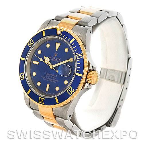 This image shows a Rolex Submariner 16613 Men's Steel and Gold (two tone) Blue Dial 16613 Men's Steel and Gold (two tone) Blue Dial watch at a three-quarter angle, highlighting the blue dial, two-tone bezel, and metal bracelet.