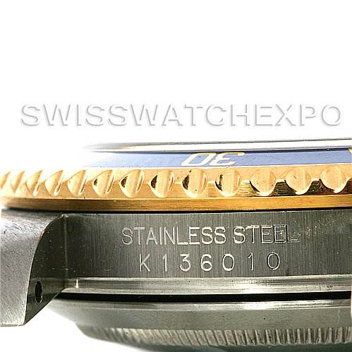 This image shows a close-up side view of the bezel, lugs, and casing of a Rolex Submariner 16613 Men's Steel and Gold (two tone) Blue Dial 16613 Men's Steel and Gold (two tone) Blue Dial watch, highlighting the "STAINLESS STEEL" inscription and serial number.