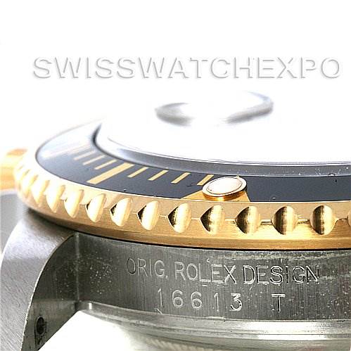This image shows a close-up angle of the bezel, crown guard, and case side of a Rolex Submariner 16613T Men's Steel and Gold (two tone) Black Dial 16613T Men's Steel and Gold (two tone) Black Dial watch, model number visible.