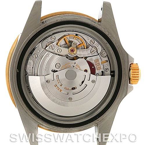 The image shows the backside of a Rolex Submariner 16613T Men's Steel and Gold (two tone) Black Dial 16613T Men's Steel and Gold (two tone) Black Dial watch, highlighting its internal mechanical movement.