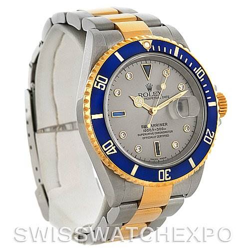 The image shows a Rolex Submariner 16613 Men's Steel and Gold (two tone) Grey Dial 16613 Men's Steel and Gold (two tone) Grey Dial watch at a three-quarter angle, highlighting its bezel, dial, and two-tone bracelet.