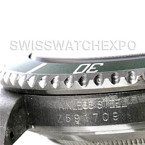 The image shows a close-up of the side view of a Rolex Submariner 16610T Men's Stainless Steel Black Dial 16610T Men's Stainless Steel Black Dial, focusing on the bezel, case, and engraved serial number.
