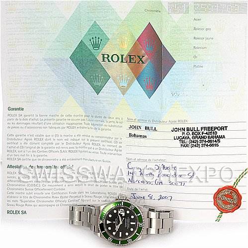 The image shows a Rolex Submariner 16610T Men's Stainless Steel Black Dial 16610T Men's Stainless Steel Black Dial watch along with its warranty and documentation from a top-down view.