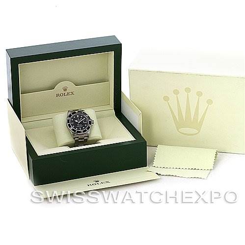 The image shows the Rolex Submariner 16610T Men's Stainless Steel Black Dial 16610T Men's Stainless Steel Black Dial watch in its box along with its packaging and a cleaning cloth.