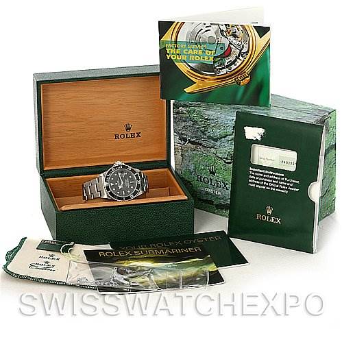 The image shows a Rolex Submariner 16610 Men's Stainless Steel Black Dial 16610 Men's Stainless Steel Black Dial watch in a display box, accompanied by the original packaging, documents, and accessories.