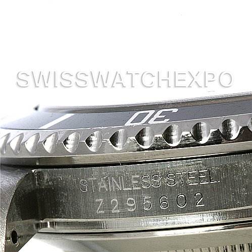 This image shows a close-up angle of the stainless steel case and bezel of a Rolex Submariner 16610 Men's Stainless Steel Black Dial 16610 Men's Stainless Steel Black Dial watch, along with its serial number.