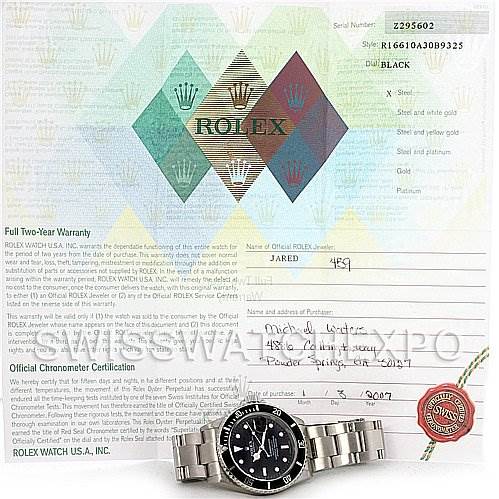 The image shows a Rolex Submariner 16610 Men's Stainless Steel Black Dial 16610 Men's Stainless Steel Black Dial watch placed on a warranty card, face and bracelet fully visible from a top-down angle.
