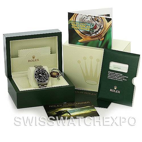 The image shows a Rolex Submariner 16610 Men's Stainless Steel Black Dial 16610 Men's Stainless Steel Black Dial watch from a front angle, along with its box, warranty card, manual, and accessories.