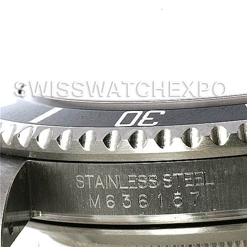 This close-up image of a Rolex Submariner 16610 Men's Stainless Steel Black Dial 16610 Men's Stainless Steel Black Dial watch shows the watch's bezel and stainless steel case with visible engraving.