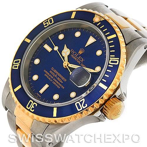 This image shows the face, bezel, and crown of the Rolex Submariner 16613 Men's Steel and Gold (two tone) Blue Dial 16613 Men's Steel and Gold (two tone) Blue Dial watch at an angle.