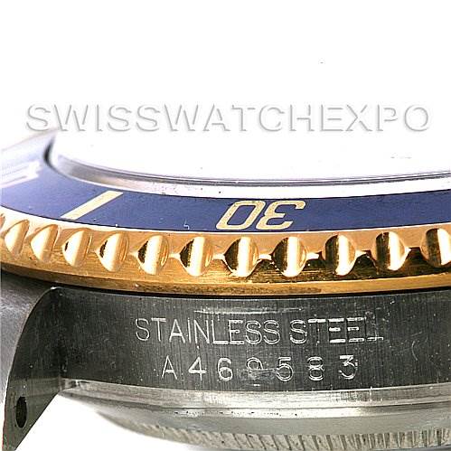 The image shows a close-up side view of a Rolex Submariner 16613 Men's Steel and Gold (two tone) Blue Dial 16613 Men's Steel and Gold (two tone) Blue Dial watch, highlighting the bezel, dial rim, and "Stainless Steel" engraving with its serial number.