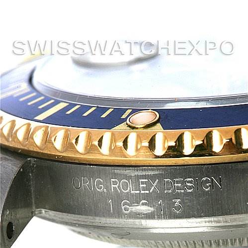 This image shows a close-up of the bezel and case side of a Rolex Submariner 16613 Men's Steel and Gold (two tone) Blue Dial 16613 Men's Steel and Gold (two tone) Blue Dial, featuring the engravings and parts of the rotating bezel.