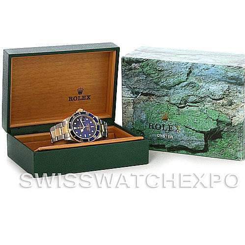 This image shows a Rolex Submariner 16613 Men's Steel and Gold (two tone) Blue Dial 16613 Men's Steel and Gold (two tone) Blue Dial watch displayed in an open box, with an additional outer packaging box visible.