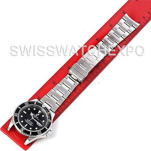 The image shows a Rolex Submariner 16610 Men's Stainless Steel Black Dial 16610 Men's Stainless Steel Black Dial watch laid flat with its band straight, set against a red ruler for measurement.