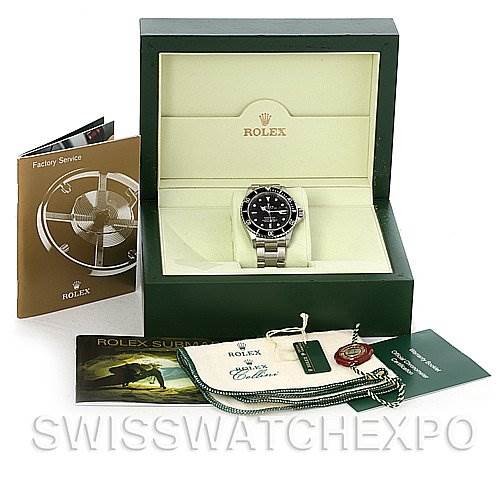 The image shows a Rolex Submariner 16610 Men's Stainless Steel Black Dial 16610 Men's Stainless Steel Black Dial watch in its box with accessories, including a booklet, tag, pouch, and warranty card.