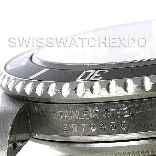 The image shows a side angle of the Rolex Submariner 16610 Men's Stainless Steel Black Dial 16610 Men's Stainless Steel Black Dial, highlighting the bezel, case, and part of the serial number engraving.