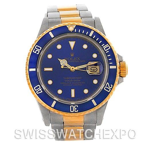 The image shows a front view of a Rolex Submariner 16803 Men's Steel and Gold (two tone) Blue Dial 16803 Men's Steel and Gold (two tone) Blue Dial watch with a blue bezel and dial, along with a metal bracelet.