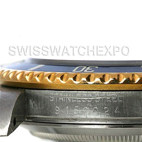 This image shows a close-up side view of the Rolex Submariner 16803 Men's Steel and Gold (two tone) Blue Dial 16803 Men's Steel and Gold (two tone) Blue Dial watch, focusing on its stainless steel case and gold bezel with the serial number visible.