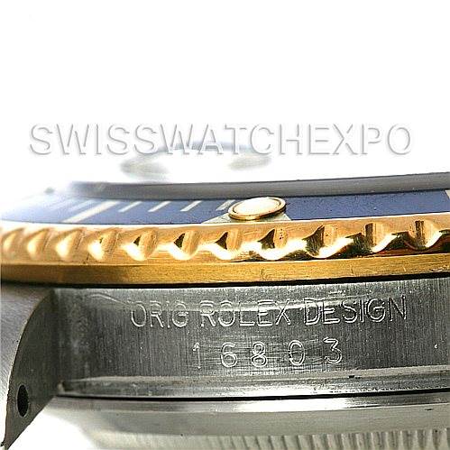 The image shows a close-up side view of a Rolex Submariner 16803 Men's Steel and Gold (two tone) Blue Dial 16803 Men's Steel and Gold (two tone) Blue Dial watch, highlighting the bezel, part of the dial, and the engraved model number.