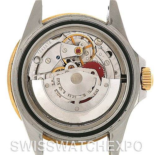This image shows the internal mechanism of a Rolex Submariner 16803 Men's Steel and Gold (two tone) Blue Dial 16803 Men's Steel and Gold (two tone) Blue Dial watch viewed from the back, revealing the movement components.