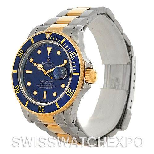 This image shows a Rolex Submariner 16803 Men's Steel and Gold (two tone) Blue Dial 16803 Men's Steel and Gold (two tone) Blue Dial watch from an angled side view, highlighting the blue dial, bezel, and two-tone metal bracelet.