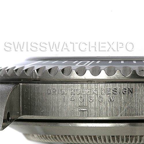 The image shows a close-up side angle of the Rolex Submariner 14060M Men's Stainless Steel Black Dial 14060M Men's Stainless Steel Black Dial case and bezel, highlighting its engravings and design details.