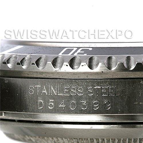 The image shows a close-up of the side of a Rolex Submariner 16610 Men
s Stainless Steel Black Dial 16610 Men
s Stainless Steel Black Dial watch, specifically highlighting the serial number and "Stainless Steel" engraving.