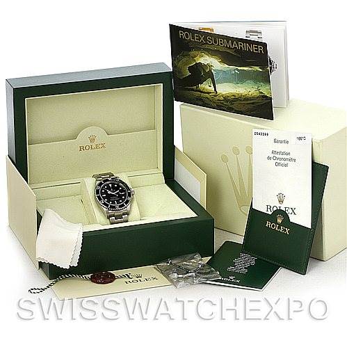 The image shows a Rolex Submariner 16610 Men
s Stainless Steel Black Dial 16610 Men
s Stainless Steel Black Dial watch with its box, manuals, and accessories, displayed from a front angle.