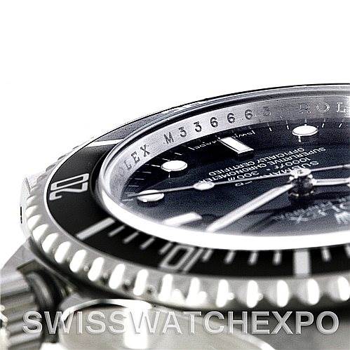 Close-up angled view of a Rolex Submariner 14060M Men's Stainless Steel Black Dial 14060M Men's Stainless Steel Black Dial watch showing the bezel, part of the dial, and the crystal with inscribed serial number.