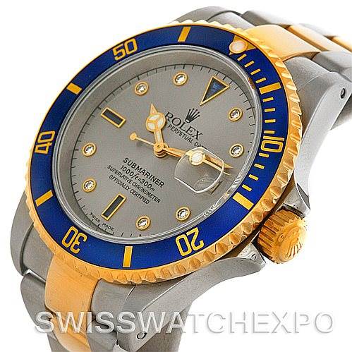 This image shows a Rolex Submariner 16613 Men's Steel and Gold (two tone) Grey Dial 16613 Men's Steel and Gold (two tone) Grey Dial watch angled slightly from above, revealing the face, bezel, case, and part of the bracelet.