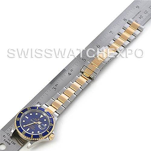 The Bentley model by Breitling is shown from a top-down angle, including the face and band, with a ruler for size reference.