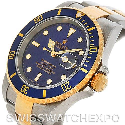 This is a diagonally-lit Rolex Submariner showing the bezel, crown, and part of the metal band.