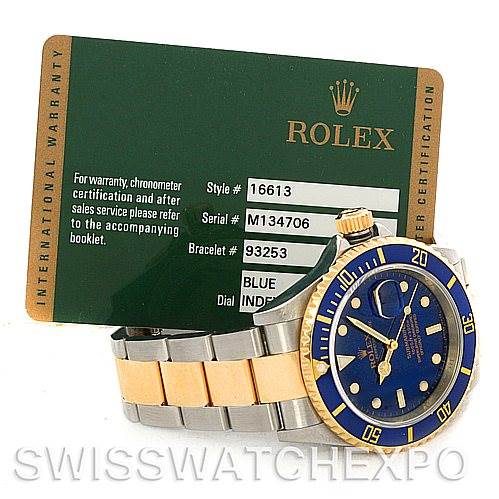 The image shows a Rolex Submariner 16613 Men's Steel and Gold (two tone) Blue Dial 16613 Men's Steel and Gold (two tone) Blue Dial watch at an angle, displaying its face, bezel, and bracelet, alongside its warranty card.